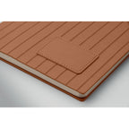 Brown leather-bound notebook with embossed texture on a white background