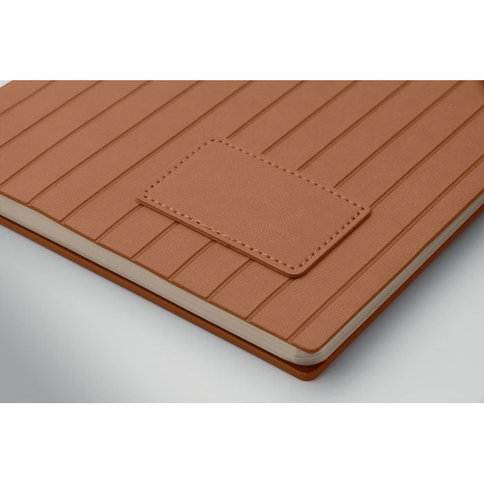 Brown leather-bound notebook with embossed texture on a white background