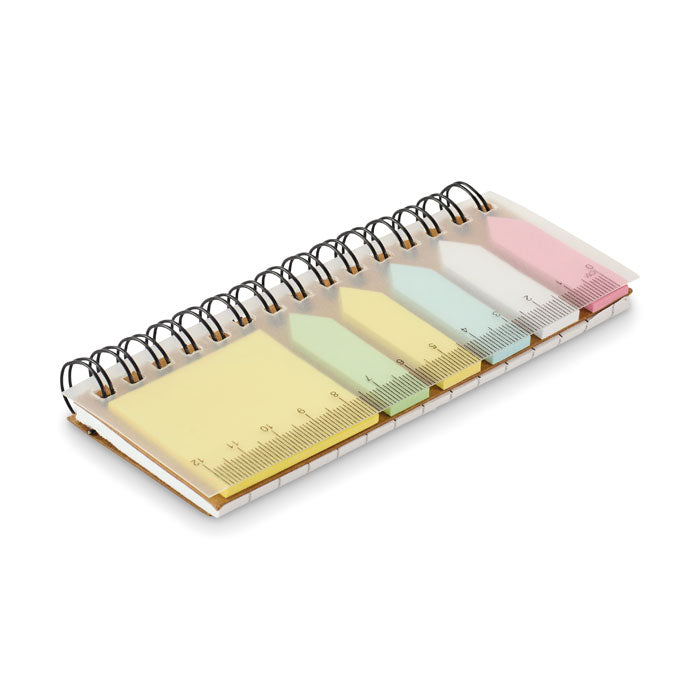 Notebook with colorful sticky notes and a ruler on a white background