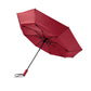 Red umbrella with black handle and ribs on a white background