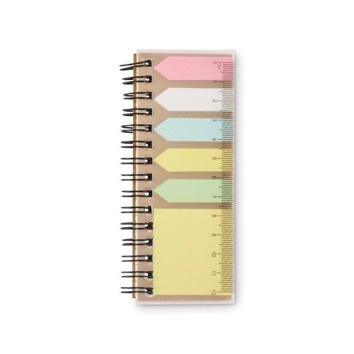 Notebook with colorful pages and a ruler on a white background
