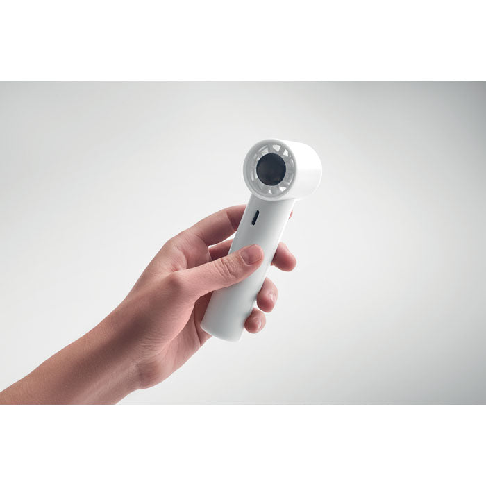 Hand holding a white handheld device against a light gray background