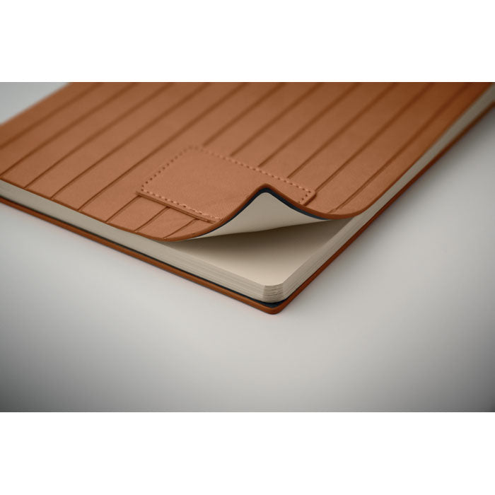 Brown leather-bound notebook on a light gray background