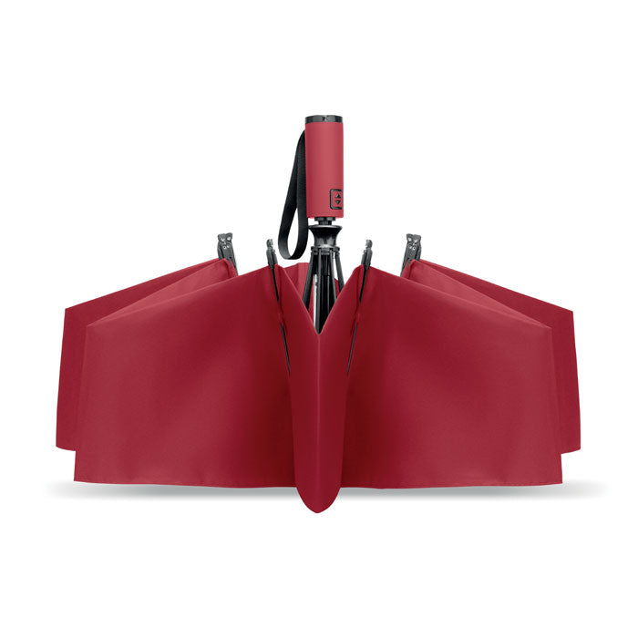 Red umbrella with a black handle on a white background