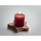 Branded star candle on wooden base, detail