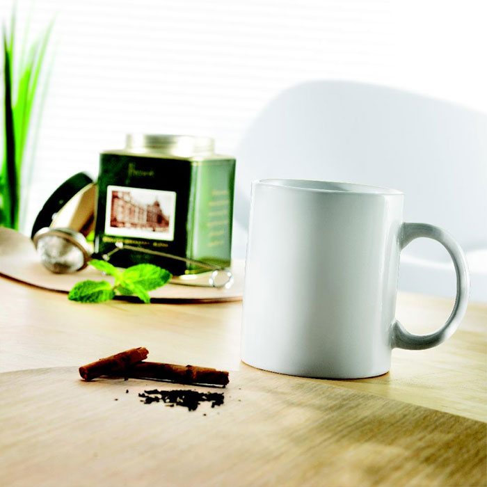Branded classic cylindrical mug in gift box, in use