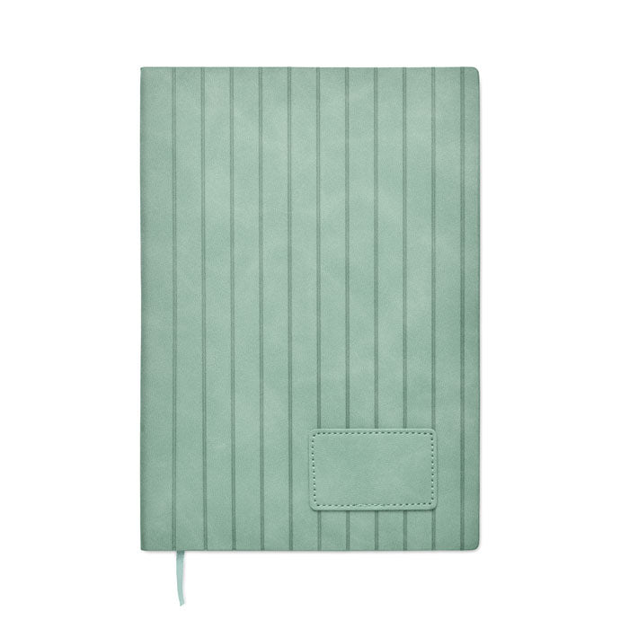 Green notebook with textured cover on a white background