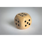 Branded Schima Wood Dice - 3cm in use