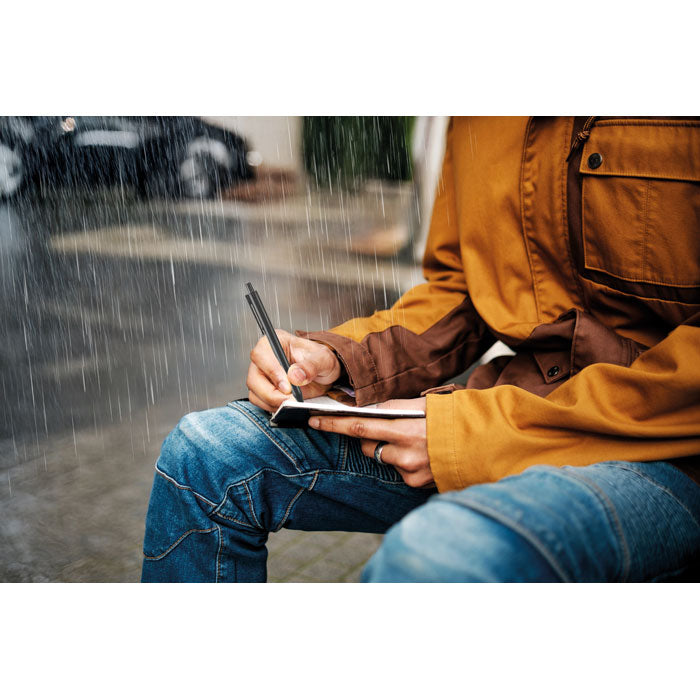 Branded Water Repellent Notepad with Pen in use