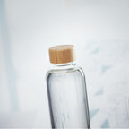 Branded glass bottle, in use