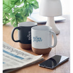 Branded matt mug with cork base, in use