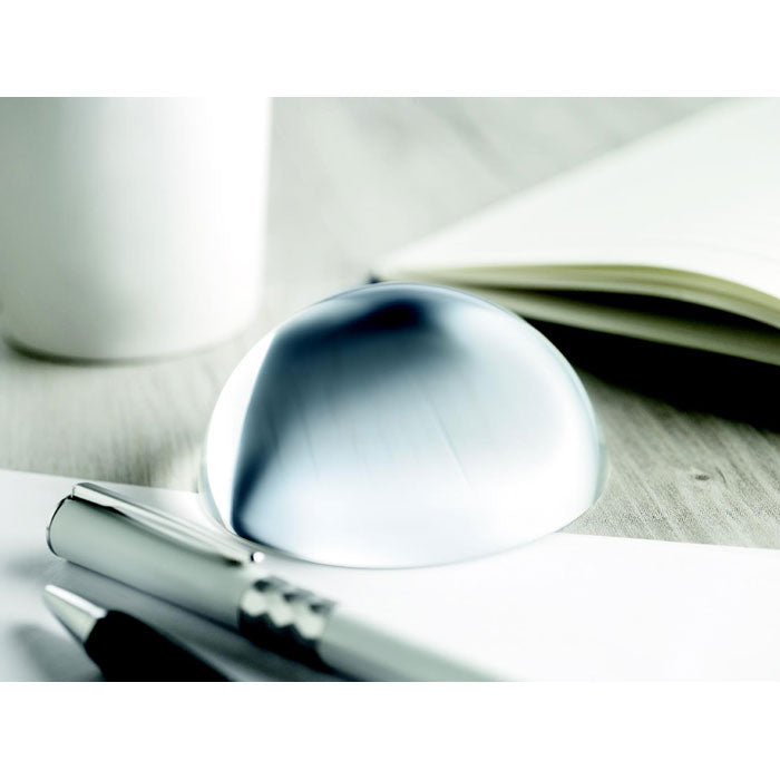 Branded Glass Ball Paperweight with Magnifier in use