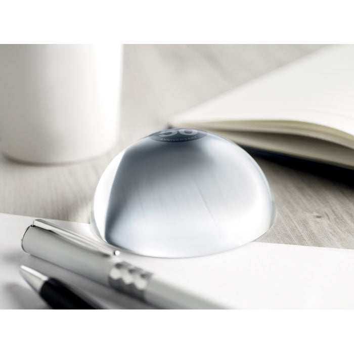 Branded Glass Ball Paperweight with Magnifier in use