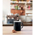 Branded heat-reveal sublimation mug, in use