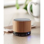 Branded Wireless Round Bamboo Speaker in use