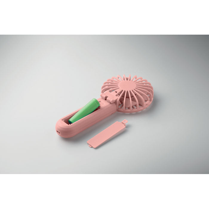 Pink handheld fan with green handle on a gray background