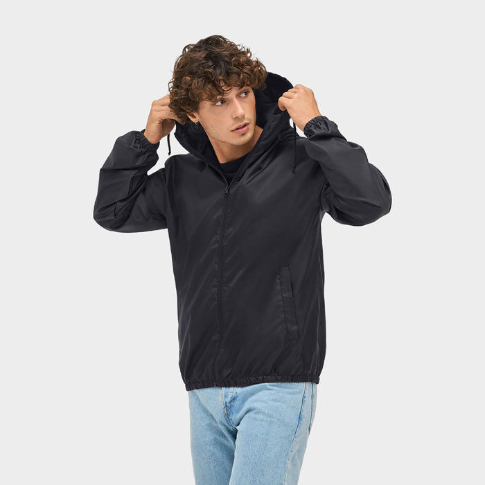 Model wearing a branded packable windbreaker