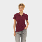 Model wearing a branded four button women's polo shirt