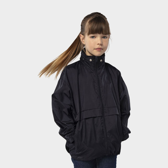 Model wearing a branded kids packable windbreaker