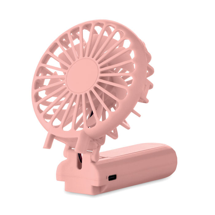 Pink portable fan with USB charging port on a white background